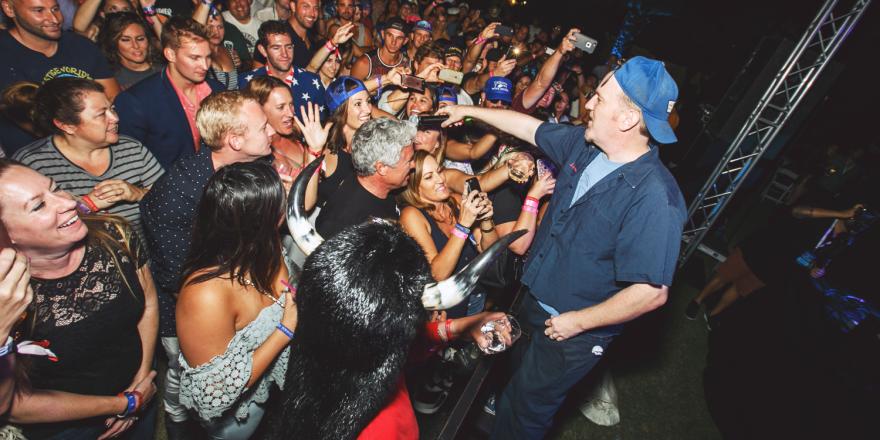 Performer on stage surrounded by a crowd at the Catalina Wine Mixer